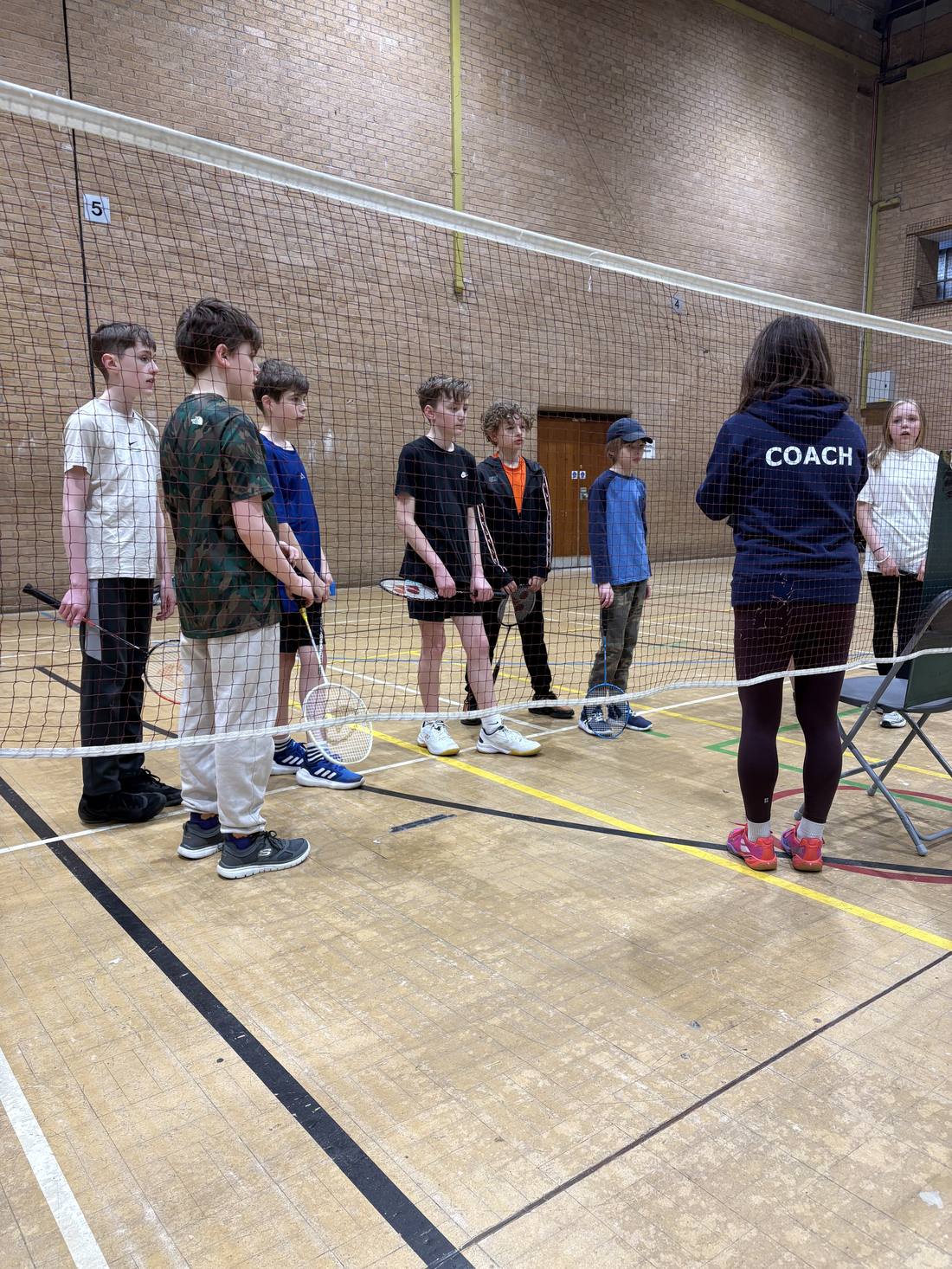 Junior badminton coaching session