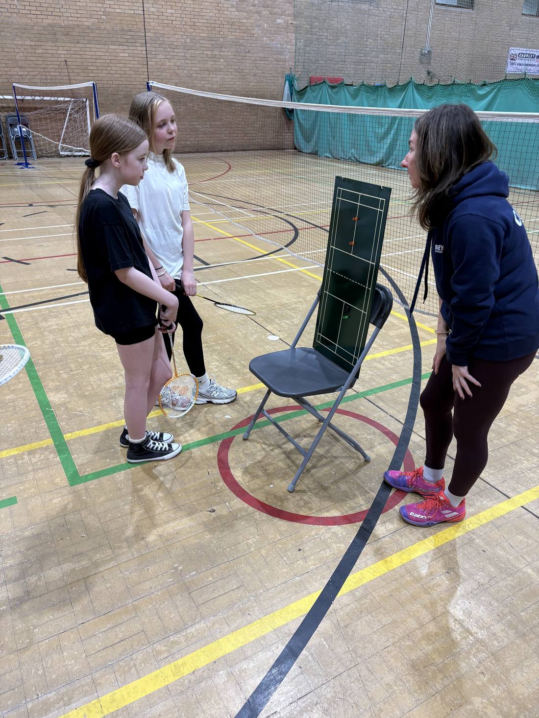 Juniors learning badminton court positions